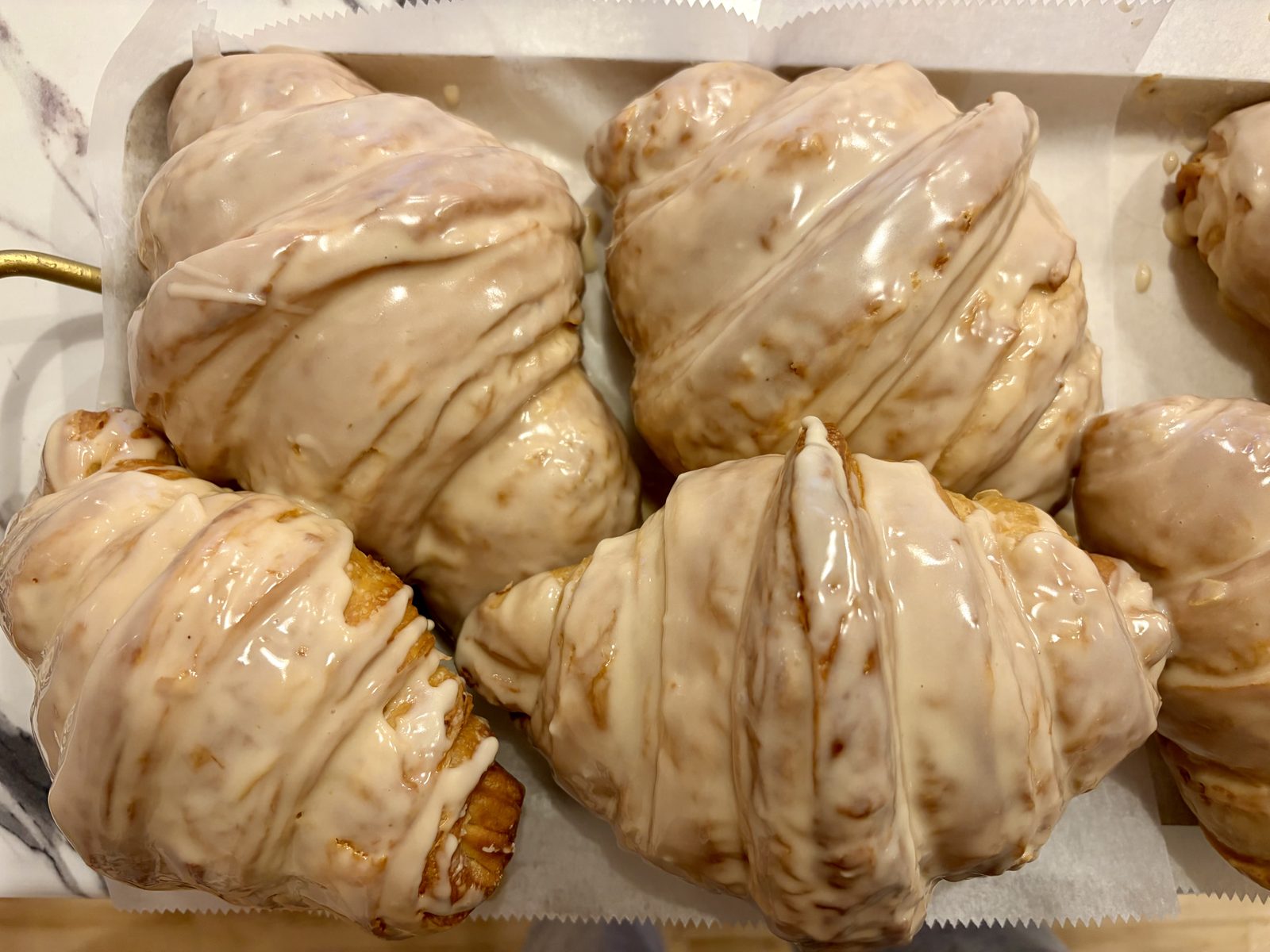 A tray of glazed croissants