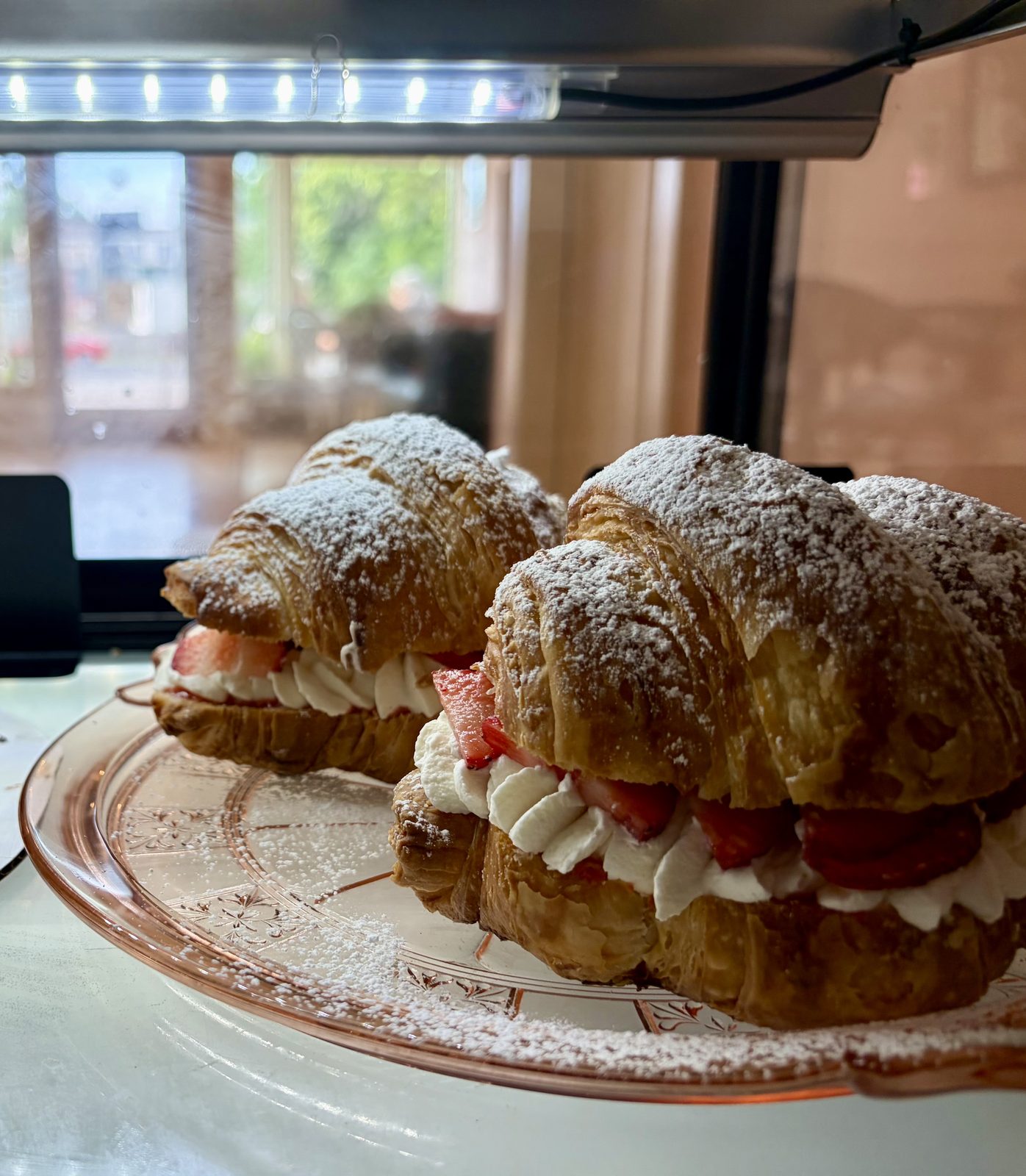 Strawberries and cream croissants in the case, with Castle Street through the window