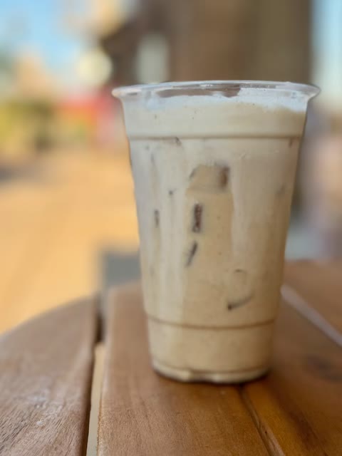 Iced latte on the table out front